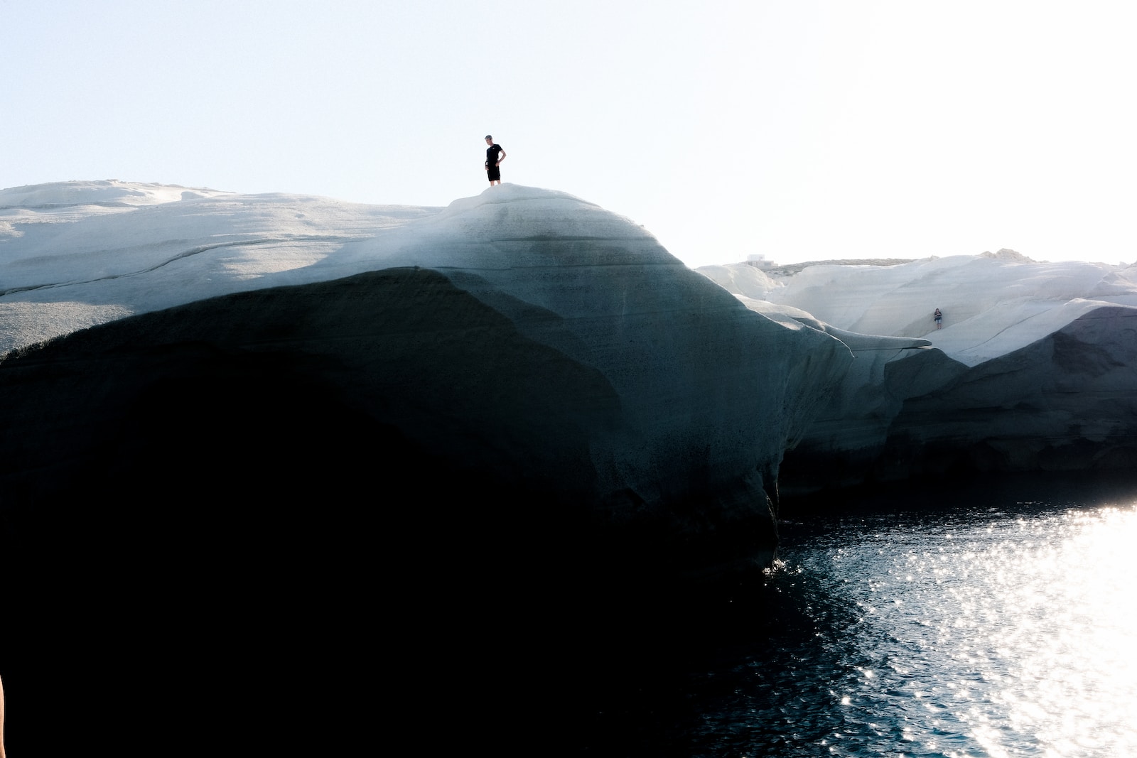 a person standing on top of a large iceberg